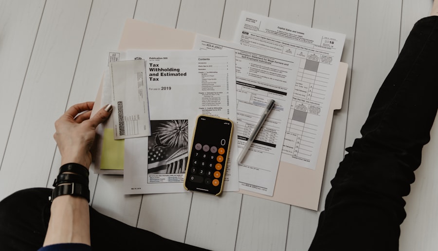 Tax forms, a calculator and planning notes laid out on a desk